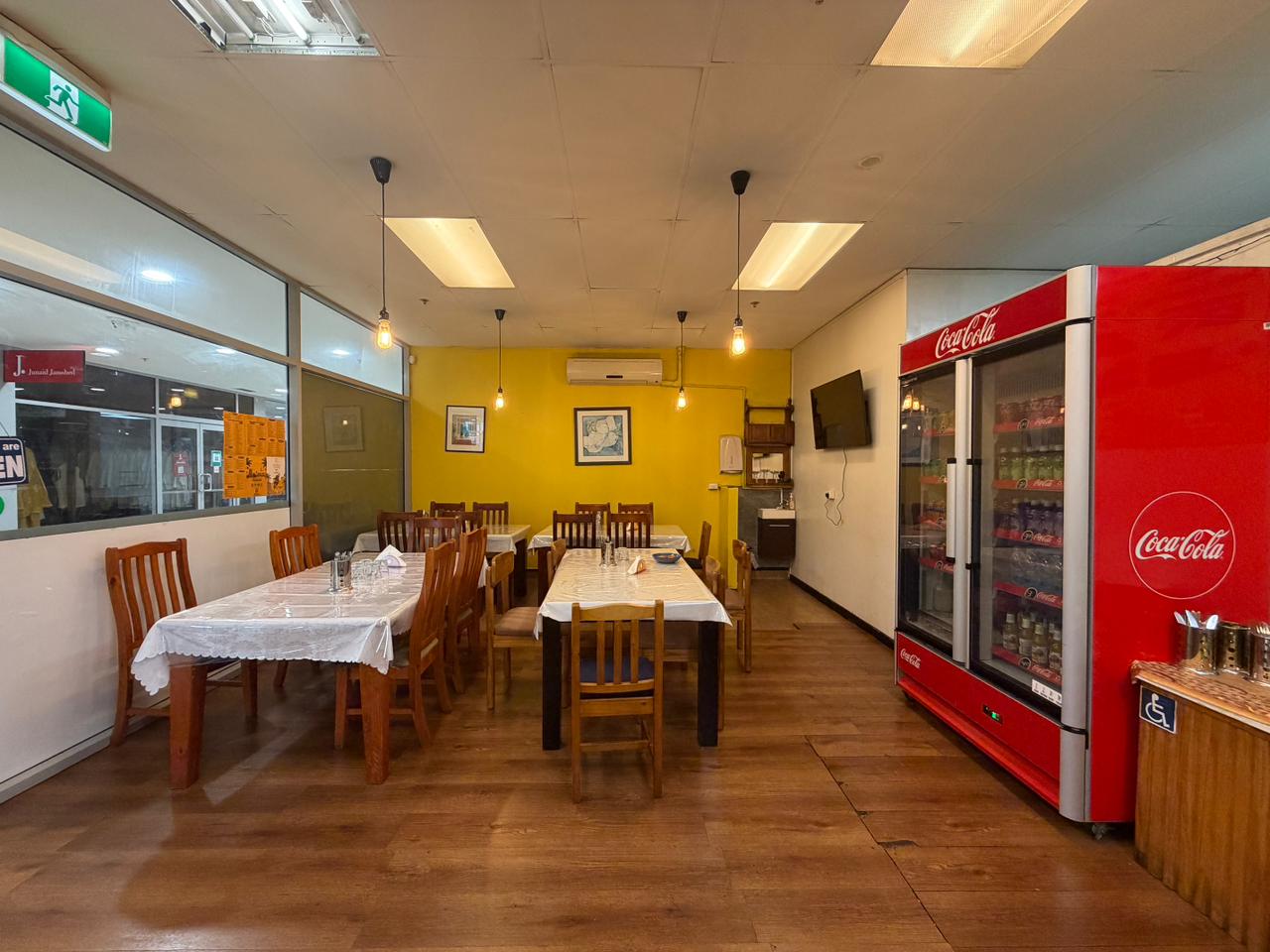 Madras Kitchen storefront glass doors and seating